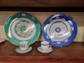 Two Christofle plates and matching cups & saucers, patterns 'Ginkgo' and 'Oceania Bleu Aida', the