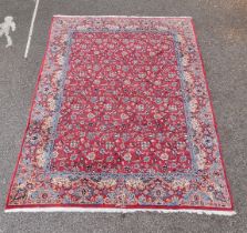 A large Persian rug, having allover floral decoration to central field and borders, floral