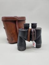 A cased pair of Canadian World War II binoculars, with broad arrow stamps.