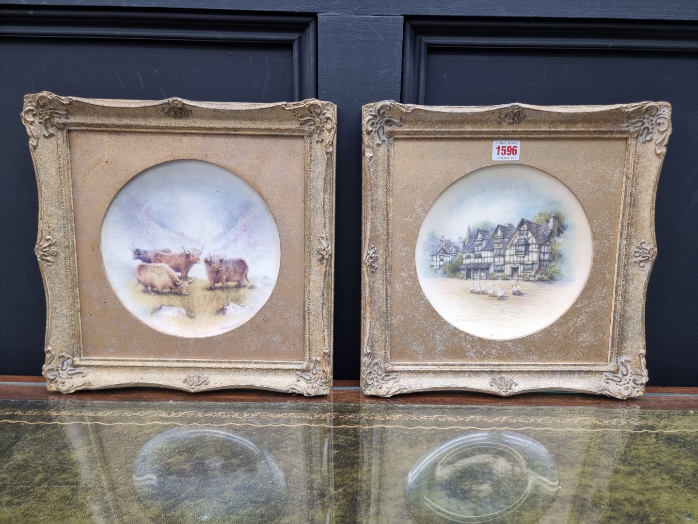 A pair of painted porcelain cabinet plates, by Christopher Hughes, in gilt frames.