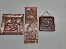 An Art Nouveau copper finger plate, 39cm high; together with a Keswick style hammered copper plaque,