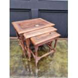 A miniature nest of three Eastern carved walnut occasional tables, largest 38cm wide.