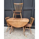 A vintage Ercol drop leaf table and three matching dining chairs, the table 125cm wide when open, (