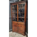 An antique mahogany standing corner display cabinet, labelled 'Muirhead Moffat & Co Antiques,