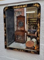 An ebonized and gilt chinoiserie framed wall mirror, 53 x 42.5cm.
