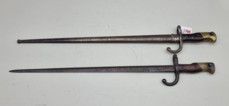 A French M1874 Gras bayonet and scabbard, St Etienne July 1878; together with another bayonet. (2)