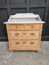 A late 19th century pine and marble top washstand, 90.5cm wide, (s.d. to marble).