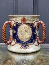 A Royal Doulton stoneware commemorative Nelson tyg, 16.5cm high.