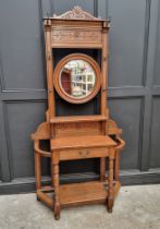 A circa 1900 carved oak hall stand, 107cm wide.