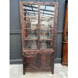 A Chinese carved hardwood display cabinet, late Qing, 195cm high x 90.5cm wide.
