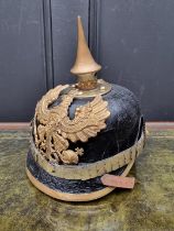 A Prussian infantry officer's pickelhaube, with eagle helmet plate and brown leather liner.