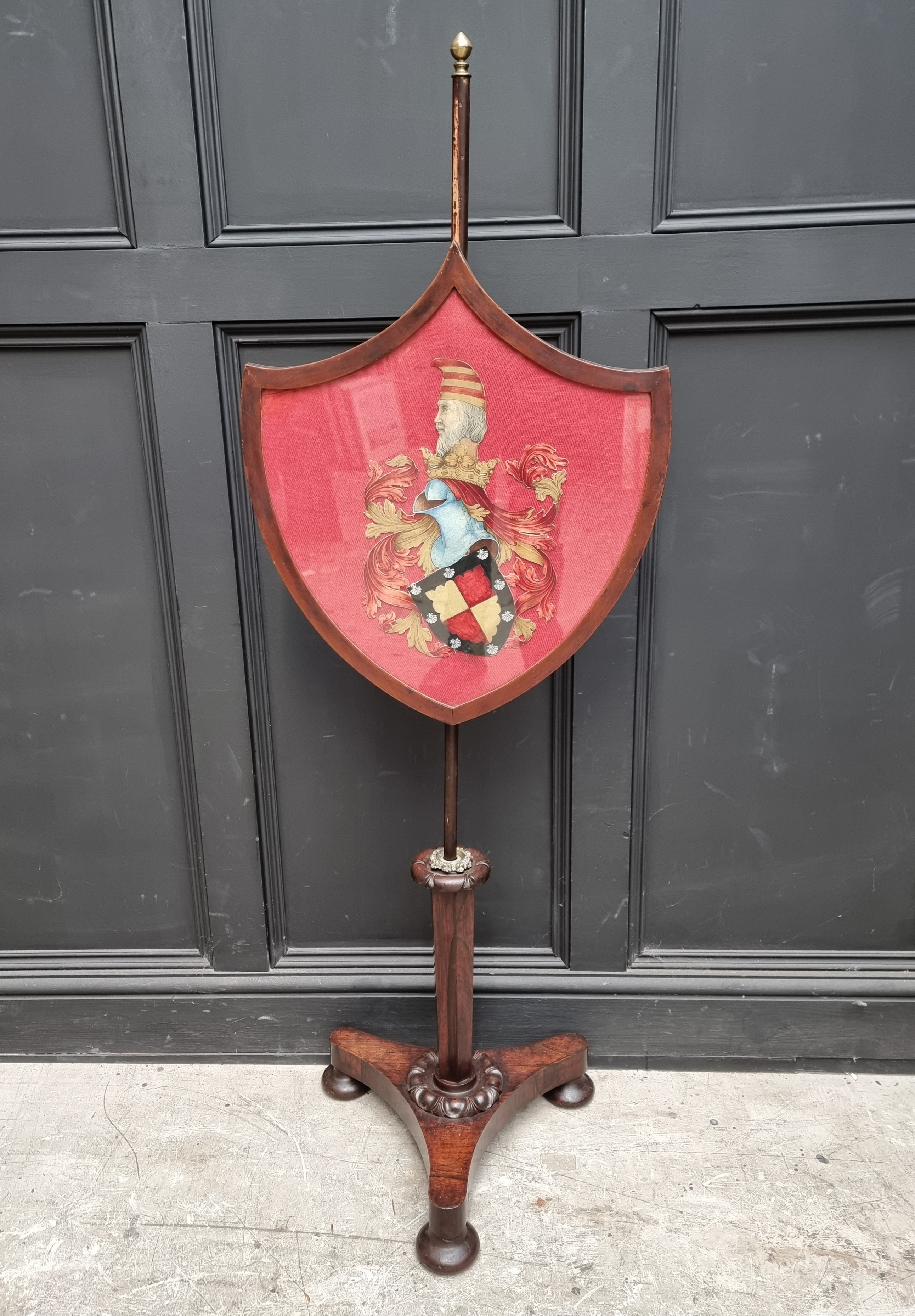 A George IV rosewood polescreen, the shield incorporating a watercolour painted crest.