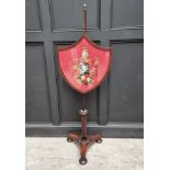 A George IV rosewood polescreen, the shield incorporating a watercolour painted crest.