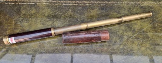 An antique mahogany and brass three draw telescope, by Dolland, London; partially cased.