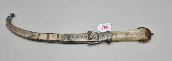 An Indian dagger and scabbard, having curved steel 22cm blade and bone grip.