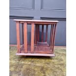 A small antique mahogany table top revolving bookcase, 34.5cm wide.