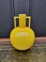 A Christopher Dresser style yellow glazed twin handled vase, 15cm high, (hairline to rim).