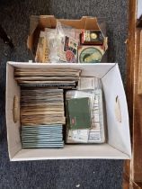 Two boxes of cigarette cards, trade cards and other ephemera.