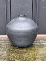 Studio Pottery: a small black glazed ovoid vase, relief monogram to base, 9.5cm high.
