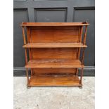 A Victorian mahogany open bookcase, 89cm wide, on brass paw feet.