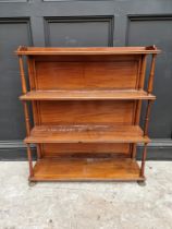 A Victorian mahogany open bookcase, 89cm wide, on brass paw feet.