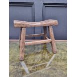 A small antique rustic pine milking stool, 33cm wide.