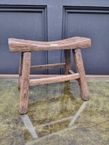 A small antique rustic pine milking stool, 33cm wide.