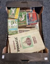 A collection of cricket and football annuals, 1930s and later; together with cigarette cards and