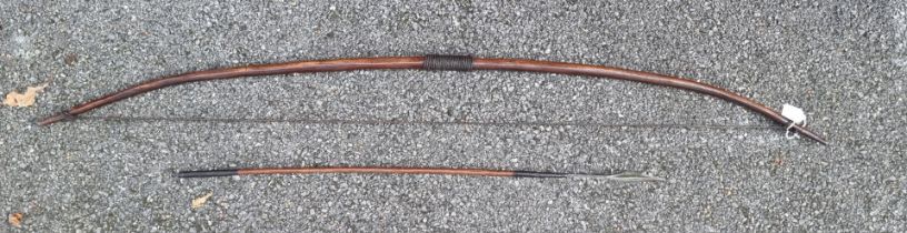Ethnographica: a bow and arrow, the bow 146.5cm long.