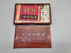 A Chinese elm cased bone and bamboo mah-jong set.
