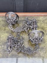A good pair of cast iron rococo style wall mounted oil lamps, 33.5cm long.