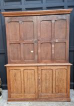 A Victorian pitch pine cabinet, with panelled doors, 216cm high x 183cm wide.