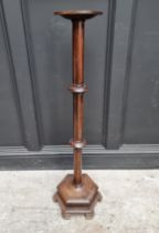 An oak torchere, with hexagonal base, 98cm high.