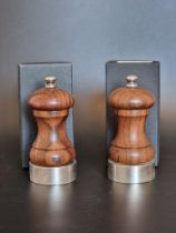 A pair of silver mounted salt and pepper grinders, London 1991, 10.5cm high, boxed.