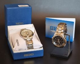 A Seiko stainless steel and gold plated solar chronograph wristwatch, Ref. V1720-0AJ0; together with