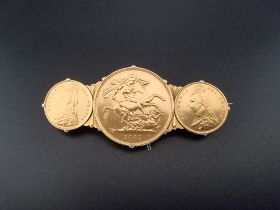 Coins: a Victoria 1887 gold double sovereign and two Victoria gold half sovereigns, in a yellow