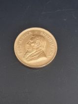 Coins: a 1974 gold krugerrand.