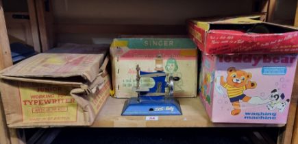 Chad Valley: a vintage boxed Hoovermatic teddy bear washing machine; together with a boxed Singer '