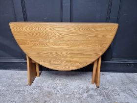 A modern Ercol pale elm drop leaf dining table, 122cm when open.