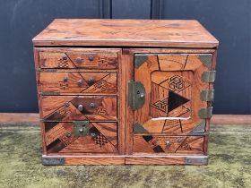 A Japanese parquetry table cabinet, 32cm wide, (formerly metamorphic).