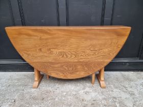 An Ercol elm drop leaf dining table, 139.5cm when open.