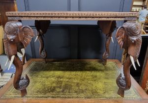 An Eastern carved hardwood rectangular low occasional table, with Elephant supports and bone