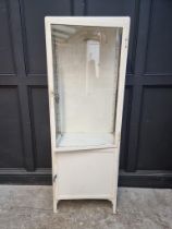 A vintage white painted metal chemist's display cabinet, 170.5 high x 60cm wide.