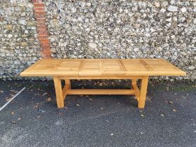 A contemporary pale oak drawleaf dining table, with two small extensions, 280cm extended.