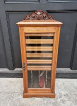 An Edwardian walnut music cabinet, with glazed panel door, 49cm wide.