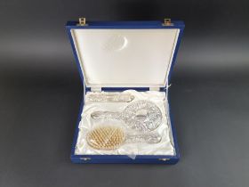 A cased silver four piece dressing table set, by W I Broadway & Co, Birmingham 2000.