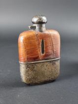 A vintage 7oz glass hip flask, having EPNS mounts with crocodile skin cover.