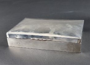 An Edwardian silver cigarette box, by William Aitken, Birmingham 1909, 17cm long.