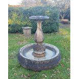 A carved white marble fountain and pool base