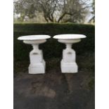 A pair of rare Handyside cast iron urns on pedestals